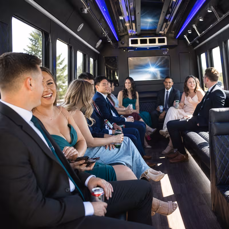 Wedding guests seated inside a Sioux Falls party bus