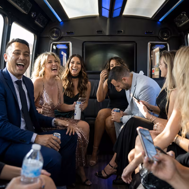 Party bus interior with wraparound leather seating and LED lighting in Sioux Falls