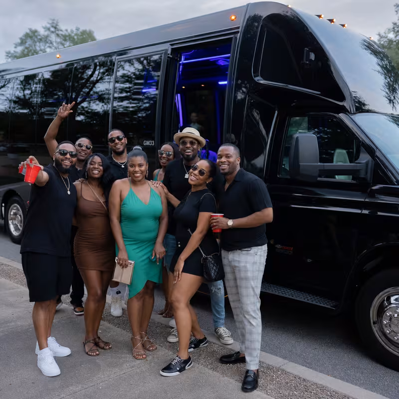 Group boarding a white charter bus for Birthday Transportation transportation in Sioux Falls
