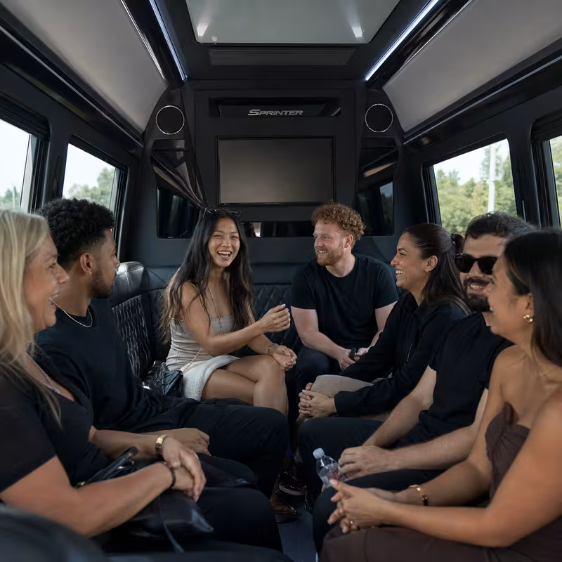 Group boarding a white charter bus for Concert Transportation transportation in Sioux Falls