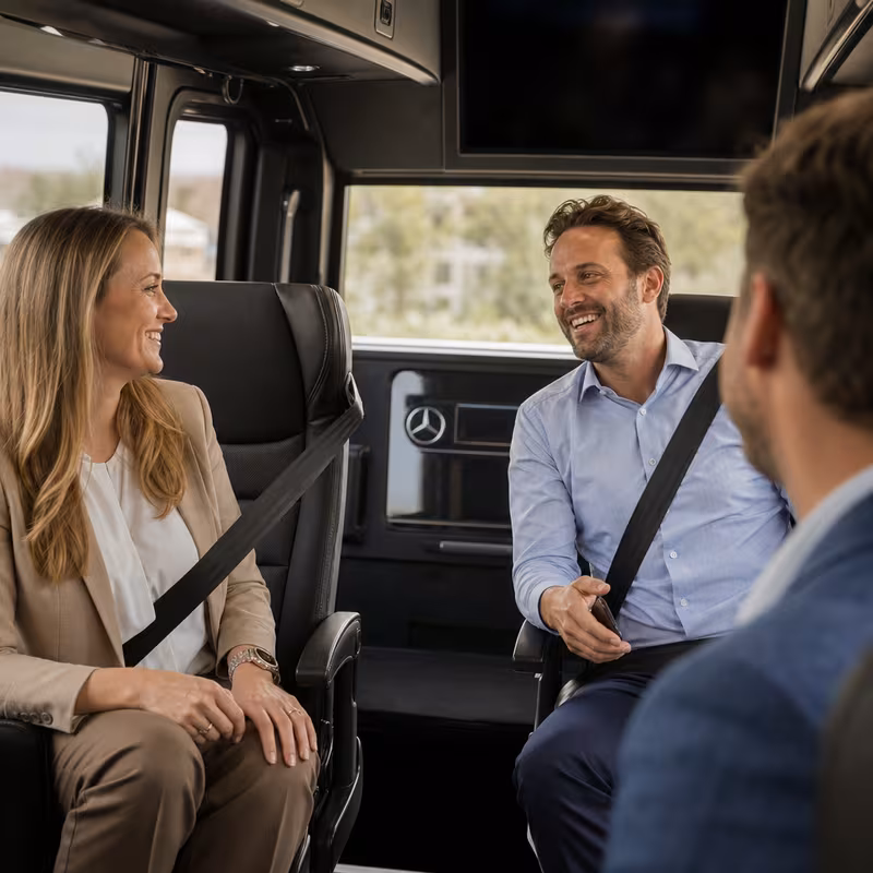 Group boarding a white charter bus for Corporate Transportation transportation in Sioux Falls