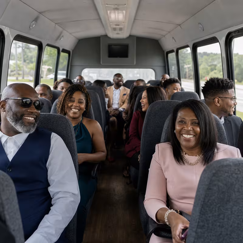 Group boarding a white charter bus for Private Event Transportation transportation in Sioux Falls