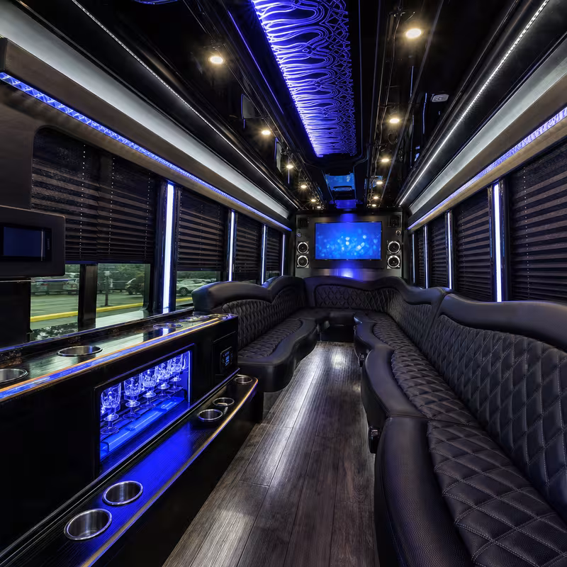Party bus interior with wraparound leather seating and LED lighting in Sioux Falls