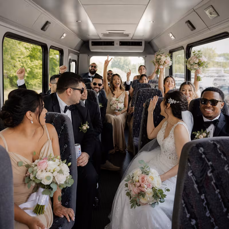 Group boarding a white charter bus for Wedding Transportation transportation in Sioux Falls