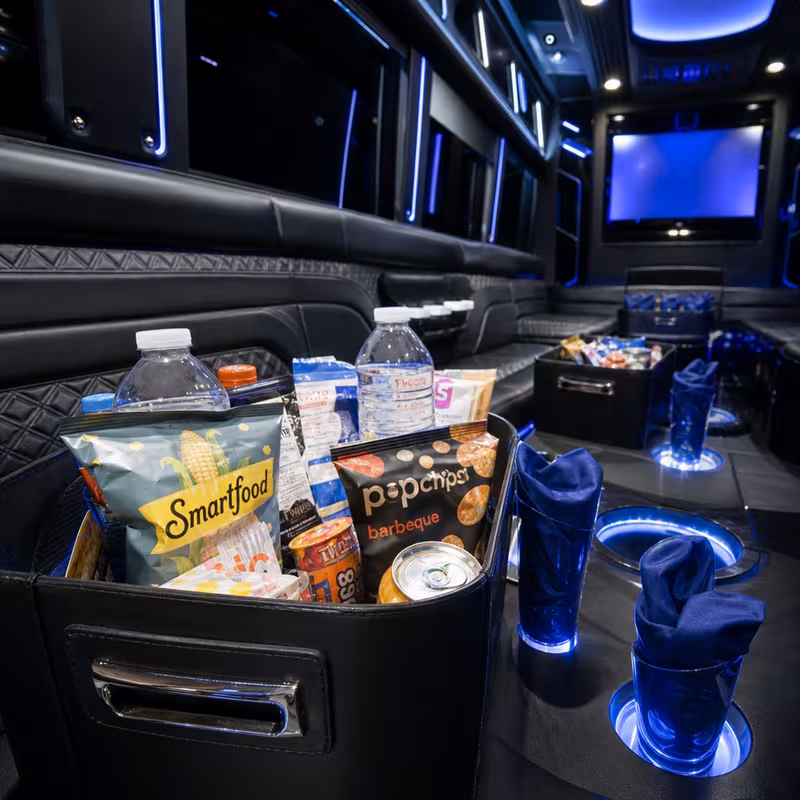 Party bus interior with wraparound leather seating and LED lighting in Sioux Falls